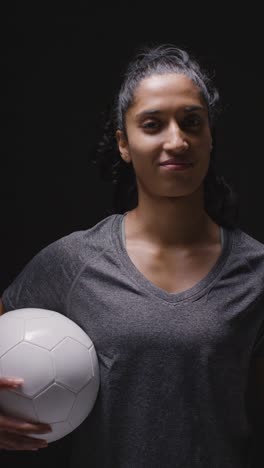 Vertical-Video-Studio-Portrait-Of-Woman-Wearing-Sports-Clothing-Against-Dark-Background